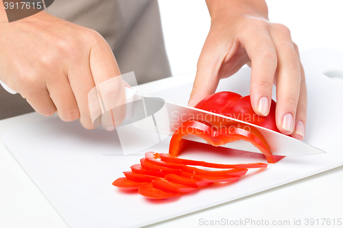 Image of Cook is chopping bell pepper