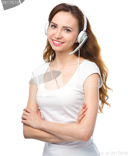 Image of Lovely young woman is talking to customers