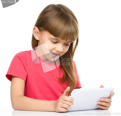 Image of Young girl is using tablet