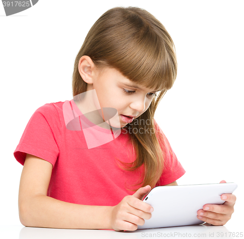 Image of Young girl is using tablet while studying