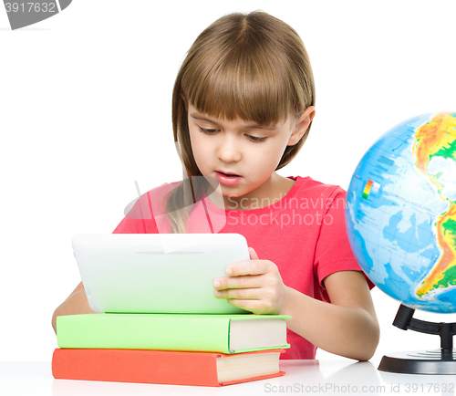 Image of Young girl is using tablet