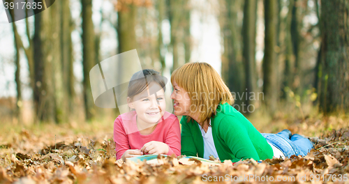 Image of Mother is reading book with her daughter