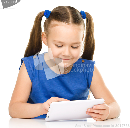 Image of Young girl is using tablet