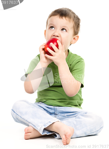 Image of Portrait of a cute little boy with red apple