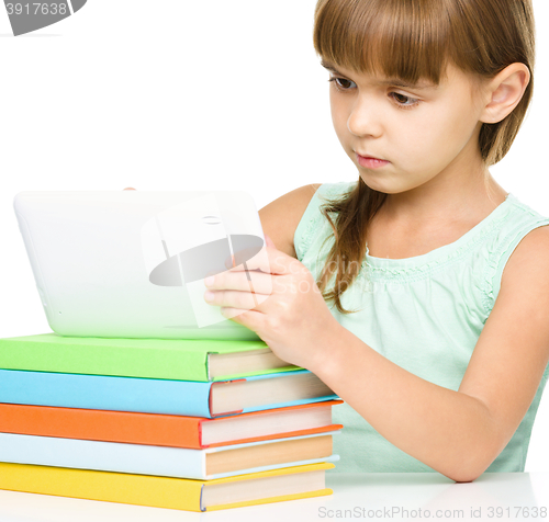Image of Young girl is using tablet