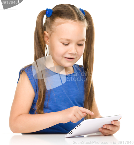 Image of Young girl is using tablet