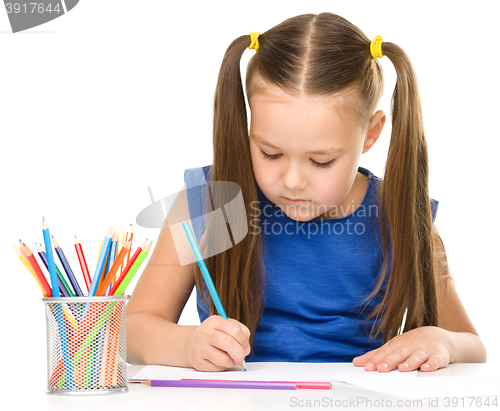 Image of Little girl is painting with gouache