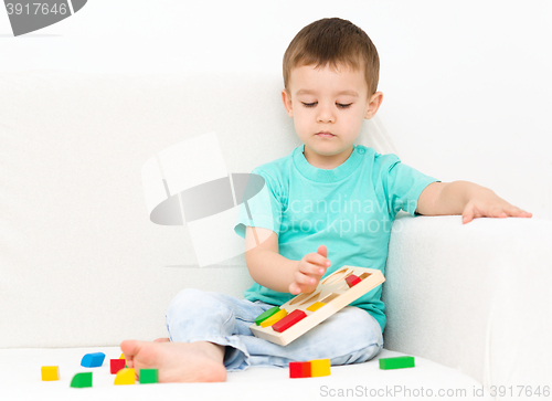 Image of Boy is playing with puzzle