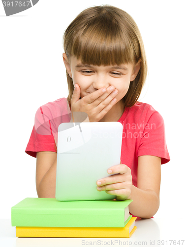 Image of Young girl is using tablet while studying