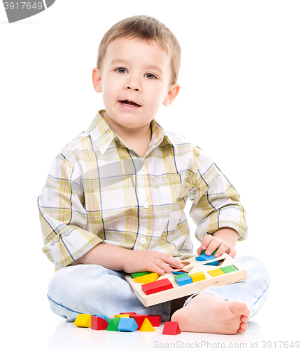 Image of Little boy is playing with toys