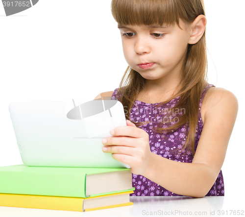 Image of Young girl is using tablet