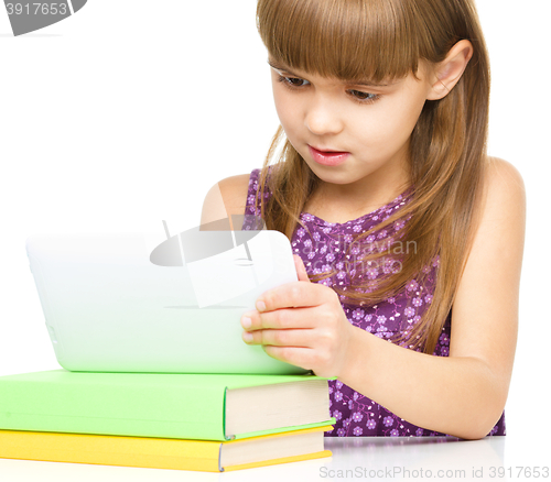 Image of Young girl is using tablet