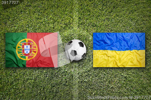 Image of Portugal vs. Ukraine flags on soccer field