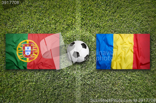 Image of Portugal vs. Romania flags on soccer field
