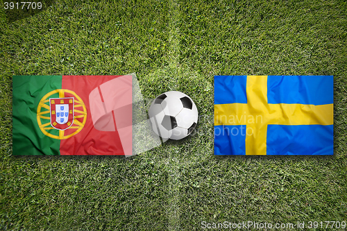 Image of Portugal vs. Sweden flags on soccer field