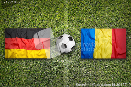 Image of Germany vs. Romania flags on soccer field