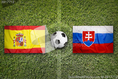 Image of Spain vs. Slovakia flags on soccer field