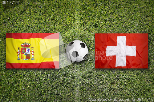 Image of Spain vs. Switzerland flags on soccer field