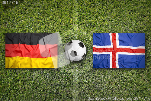 Image of Germany vs. Iceland flags on soccer field