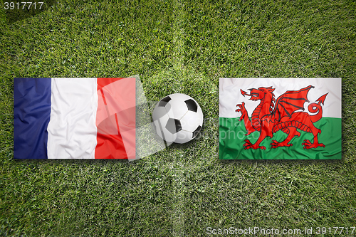 Image of France vs. Wales flags on soccer field