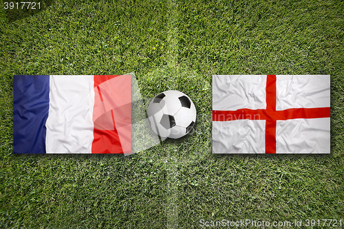 Image of France vs. England flags on soccer field