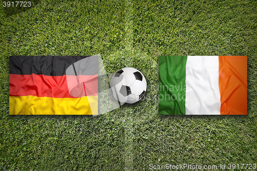 Image of Germany vs. Ireland flags on soccer field