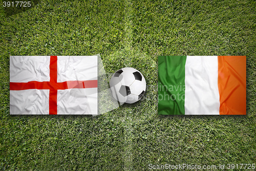 Image of England vs. Ireland flags on soccer field