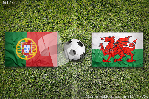 Image of Portugal vs. Wales flags on soccer field