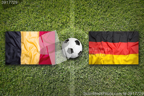 Image of Belgium vs. Germany flags on soccer field