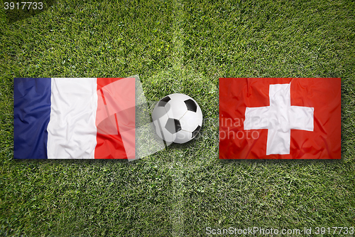 Image of France vs. Switzerland flags on soccer field