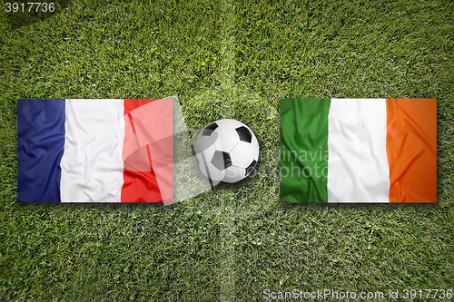 Image of France vs. Ireland flags on soccer field