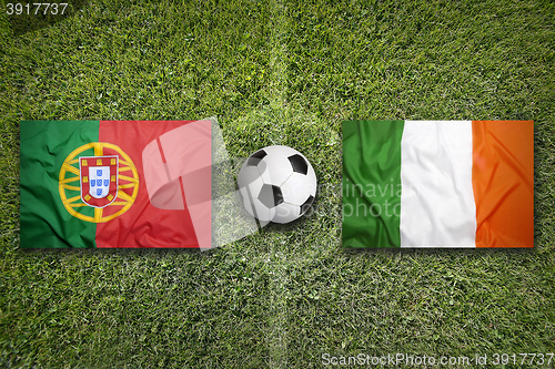 Image of Portugal vs. Ireland flags on soccer field