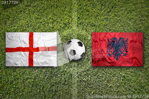 Image of England vs. Albania flags on soccer field