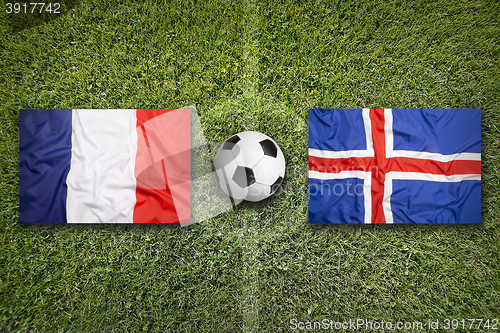 Image of France vs. Iceland flags on soccer field