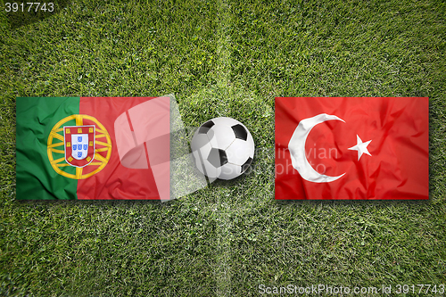 Image of Portugal vs. Turkey flags on soccer field