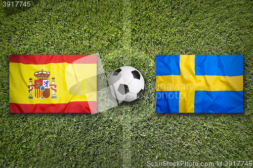 Image of Spain vs. Sweden flags on soccer field