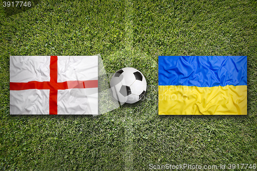 Image of England vs. Ukraine flags on soccer field