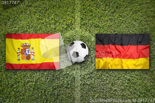 Image of Spain vs. Germany flags on soccer field