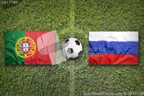 Image of Portugal vs. Russia flags on soccer field