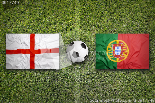 Image of England vs. Portugal flags on soccer field