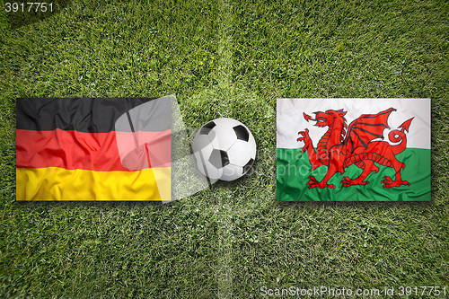 Image of Germany vs. Wales flags on soccer field