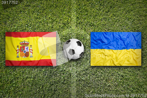 Image of Spain vs. Ukraine flags on soccer field