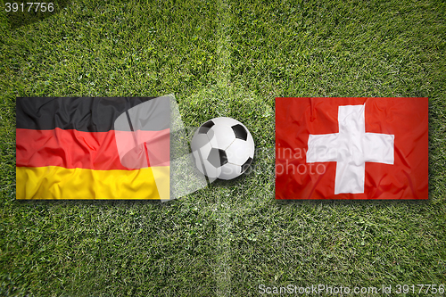 Image of Germany vs. Switzerland flags on soccer field