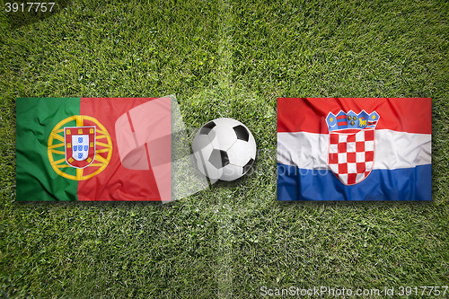 Image of Portugal vs. Croatia flags on soccer field