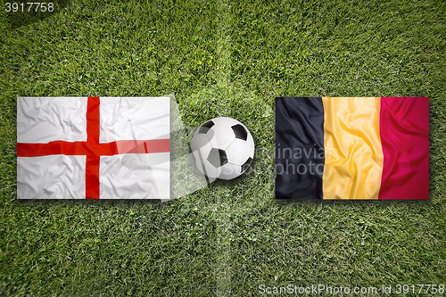 Image of England vs. Belgium flags on soccer field