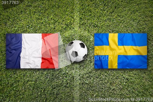 Image of France vs. Sweden flags on soccer field
