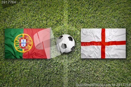 Image of Portugal vs. England flags on soccer field