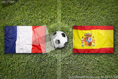 Image of France vs. Spain flags on soccer field