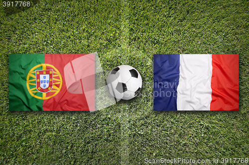 Image of Portugal vs. France flags on soccer field