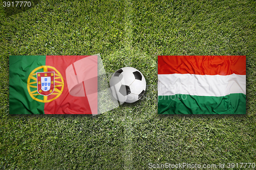 Image of Portugal vs. Hungary flags on soccer field